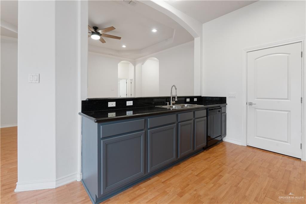 3315 Omega Street Edinburg, TX 78539 - Photo 5 of 19 Bar with dark countertops, light wood-style flooring, ceiling fan, dishwasher, and recessed lighting