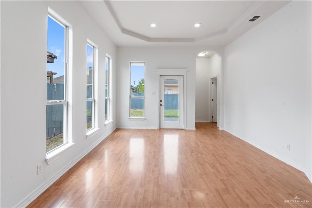 3315 Omega Street Edinburg, TX 78539 - Photo 6 of 19 Spare room featuring a raised ceiling, light wood finished floors, and arched walkways