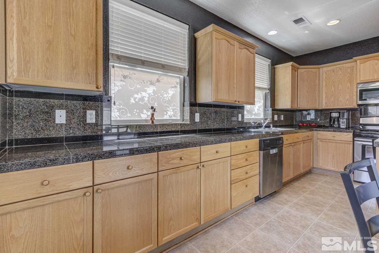 9070 Jack Hammer Drive Reno, NV 89521 - Photo 19 of 40 a kitchen with sink window and cabinets