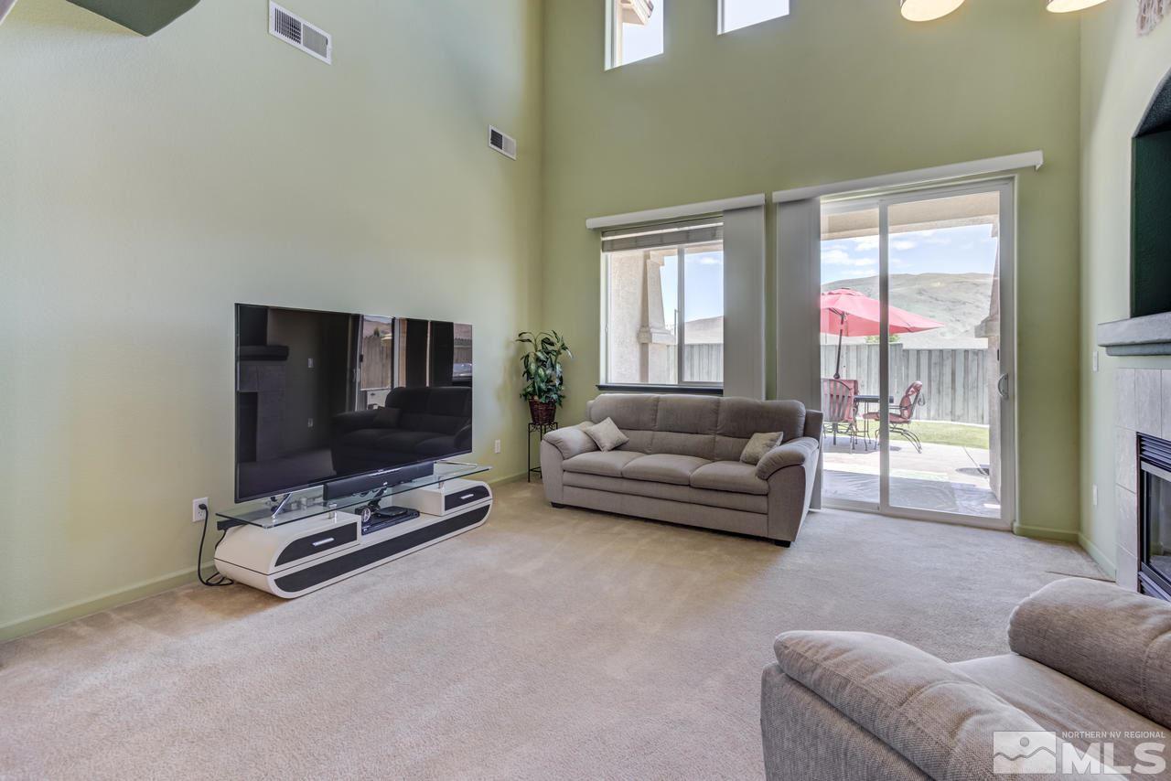 9070 Jack Hammer Drive Reno, NV 89521 - Photo 21 of 40 a living room with furniture and a flat screen tv