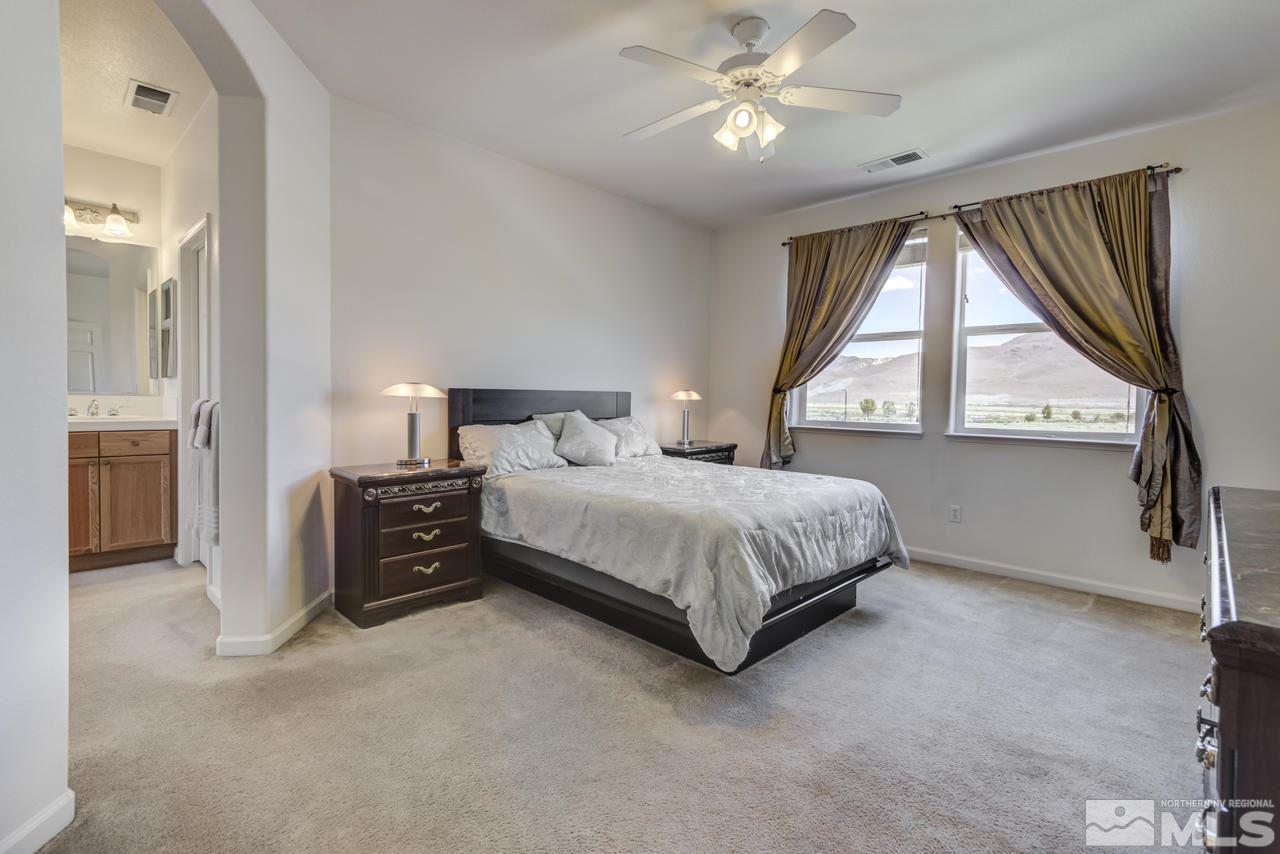 9070 Jack Hammer Drive Reno, NV 89521 - Photo 24 of 40 a bedroom with a large bed and a window
