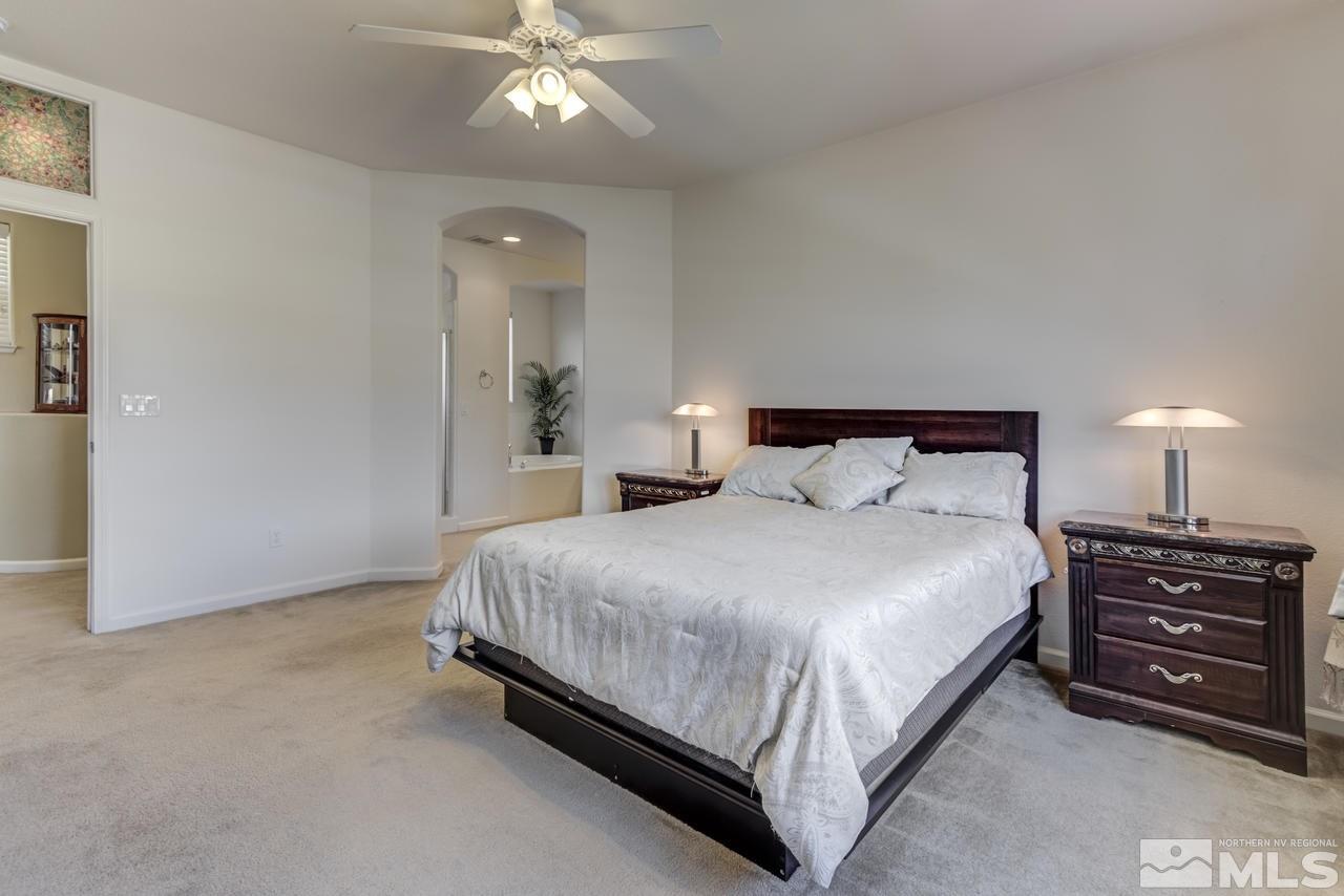 9070 Jack Hammer Drive Reno, NV 89521 - Photo 25 of 40 a bedroom with a bed and a chandelier