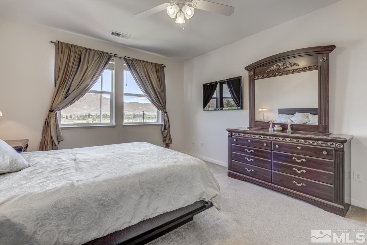 9070 Jack Hammer Drive Reno, NV 89521 - Photo 27 of 40 a bedroom with a bed and a large window