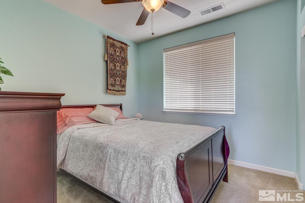 9070 Jack Hammer Drive Reno, NV 89521 - Photo 30 of 40 a bedroom with a bed and a chandelier