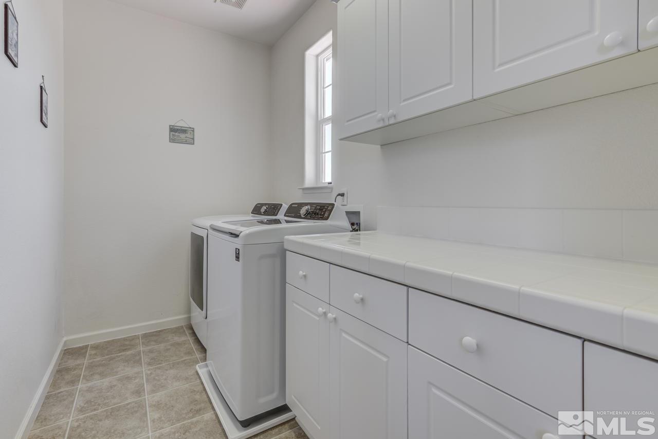 9070 Jack Hammer Drive Reno, NV 89521 - Photo 36 of 40 a utility room with cabinets washer and dryer