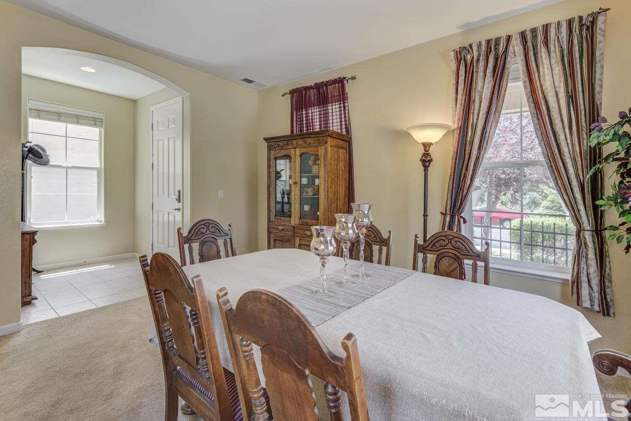 9070 Jack Hammer Drive Reno, NV 89521 - Photo 8 of 40 a view of a dining room with furniture and wooden floor