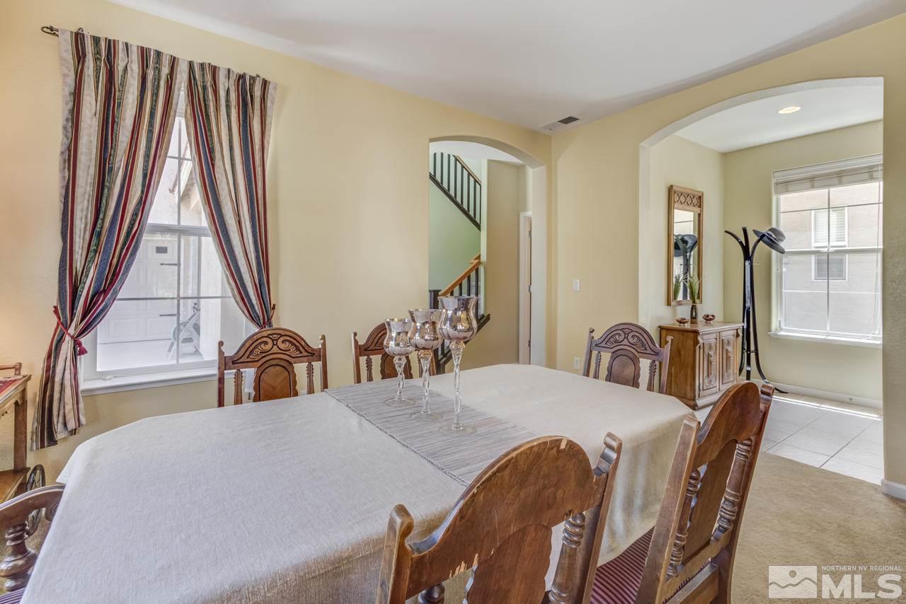 9070 Jack Hammer Drive Reno, NV 89521 - Photo 9 of 40 a view of a dining room with furniture and a chandelier