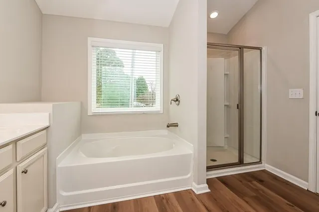 a white bath tub sitting next to a window