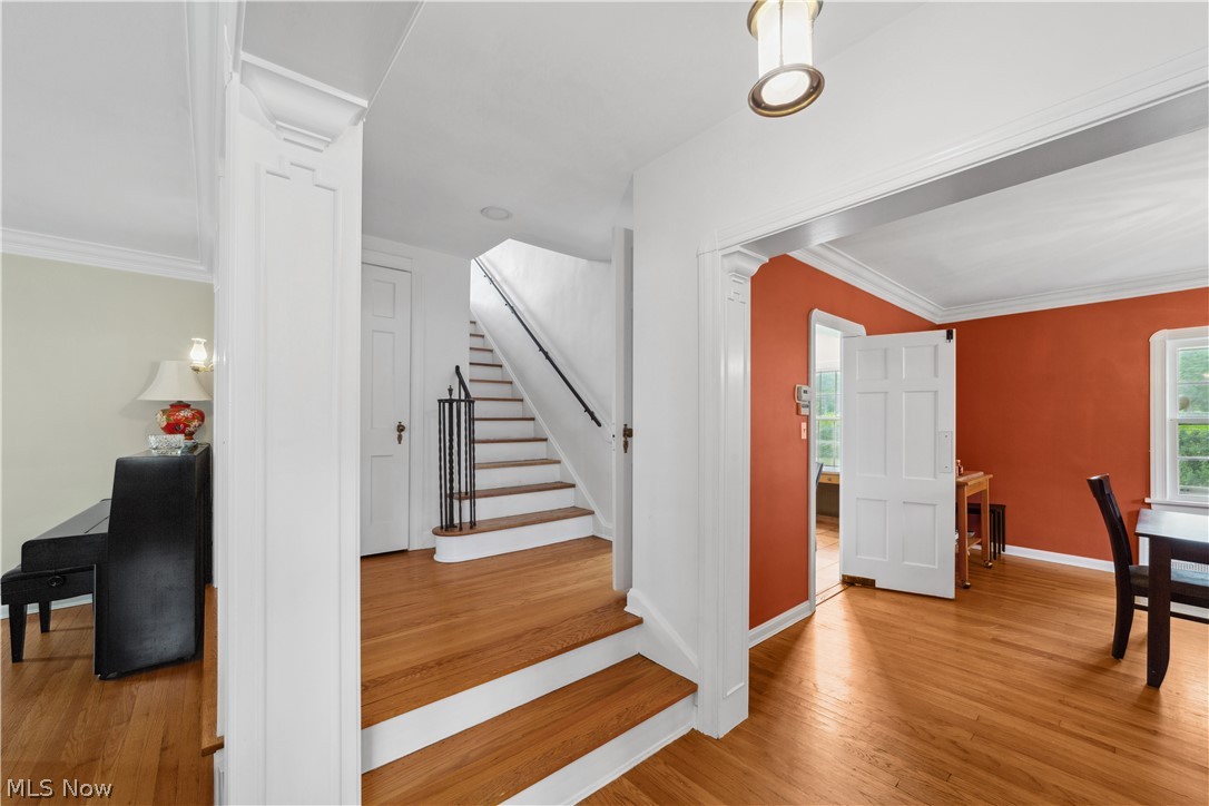 3045 Keswick Road Cleveland, OH 44120 - Photo 8 of 48 Staircase with light hardwood / wood-style floors, ornamental molding, and decorative columns