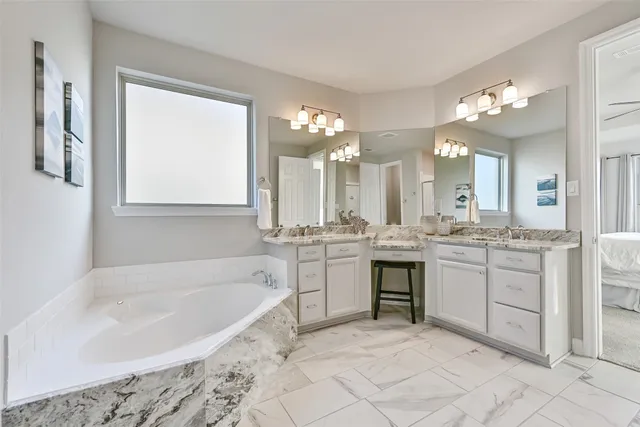 a bedroom with a bed and a ceiling fan