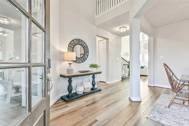 a living room with furniture a fireplace and a floor to ceiling window