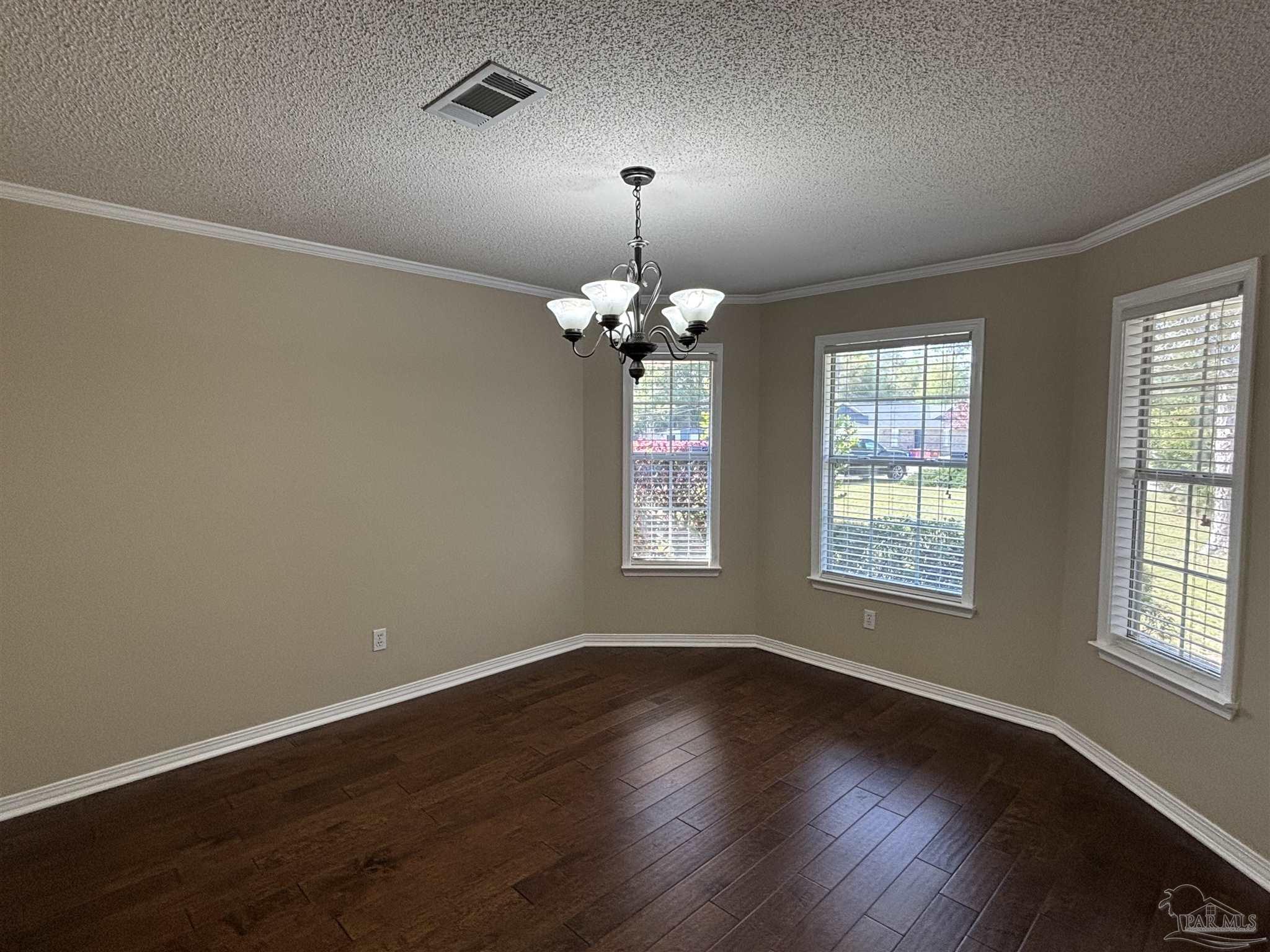 5309 Gillette Way Milton, FL 32570 - Photo 14 of 51 a room with wooden floor chandelier and window