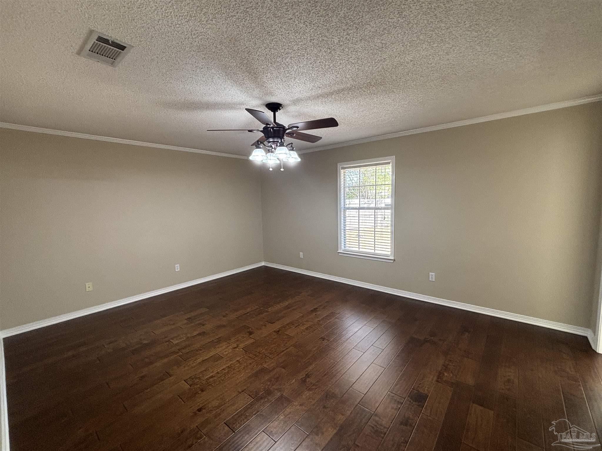 5309 Gillette Way Milton, FL 32570 - Photo 15 of 51 a view of an empty room with wooden floor and a window