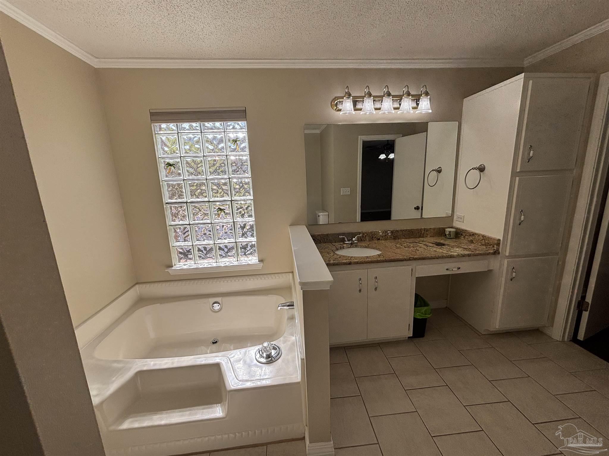 5309 Gillette Way Milton, FL 32570 - Photo 16 of 51 a bathroom with a sink a bathtub and a window