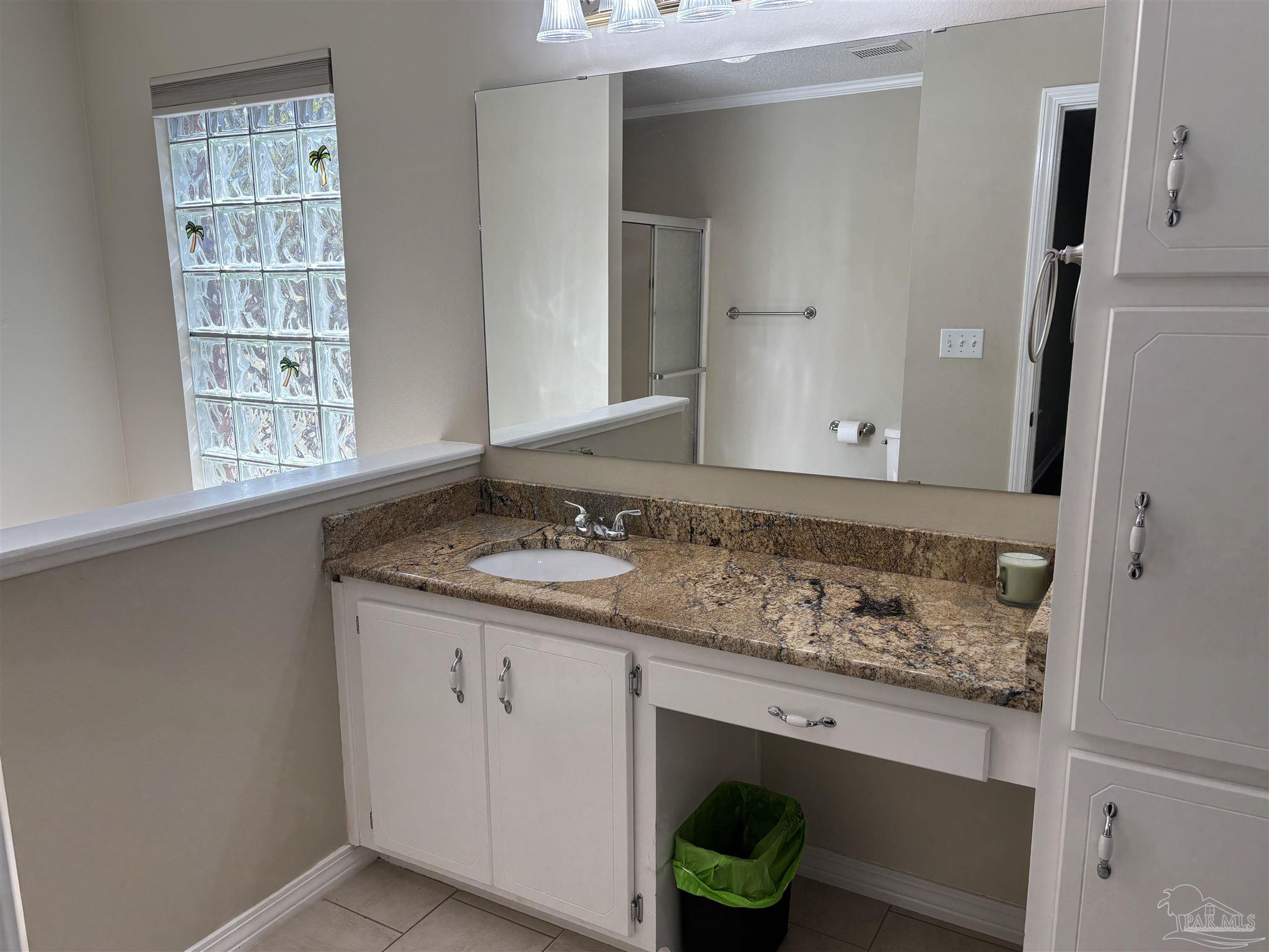 5309 Gillette Way Milton, FL 32570 - Photo 18 of 51 a bathroom with a granite countertop sink and a window
