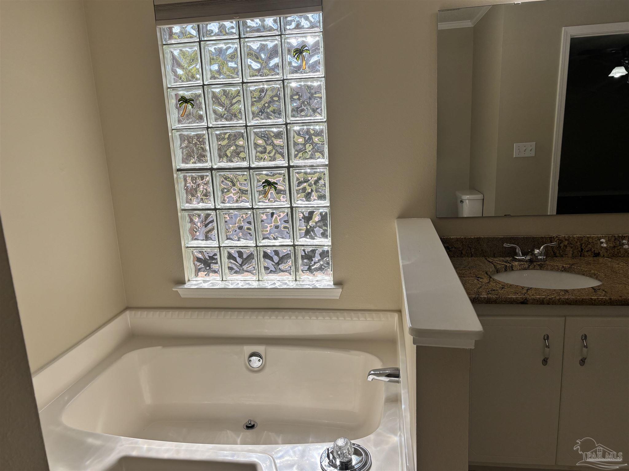 5309 Gillette Way Milton, FL 32570 - Photo 20 of 51 a bathroom with a granite countertop sink and window