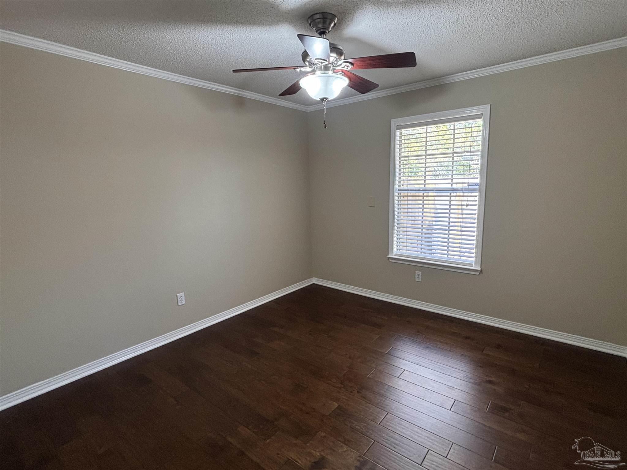 5309 Gillette Way Milton, FL 32570 - Photo 23 of 51 a view of an empty room with wooden floor and a window