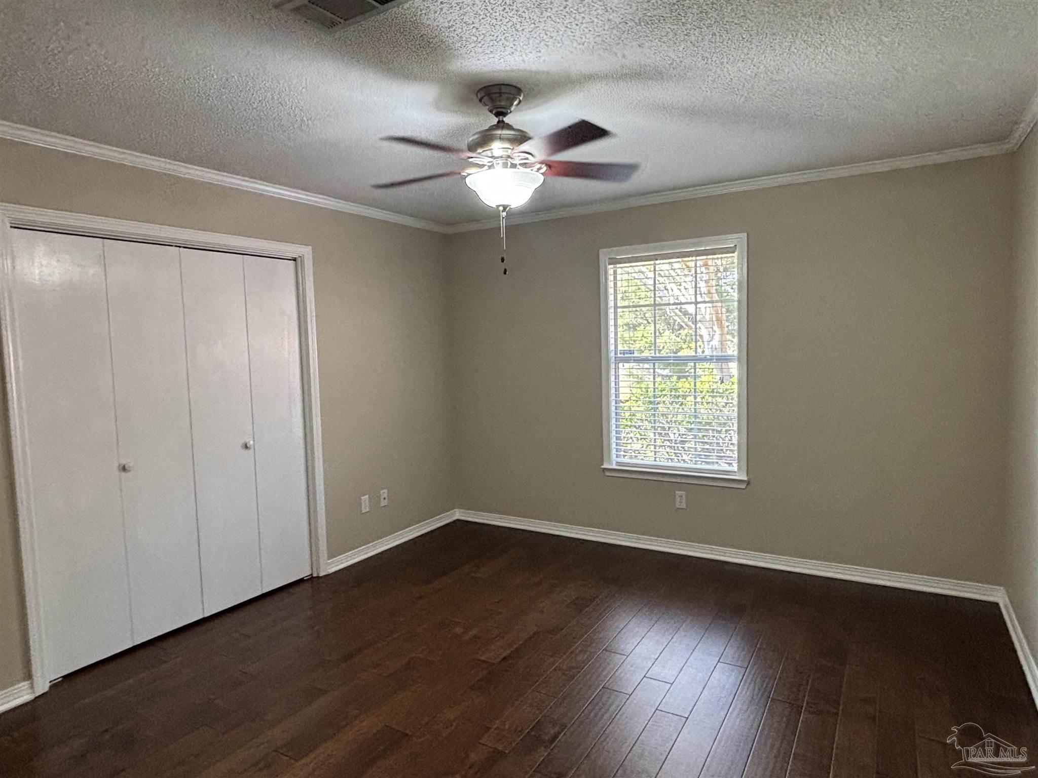 5309 Gillette Way Milton, FL 32570 - Photo 24 of 51 a view of an empty room with wooden floor and a window