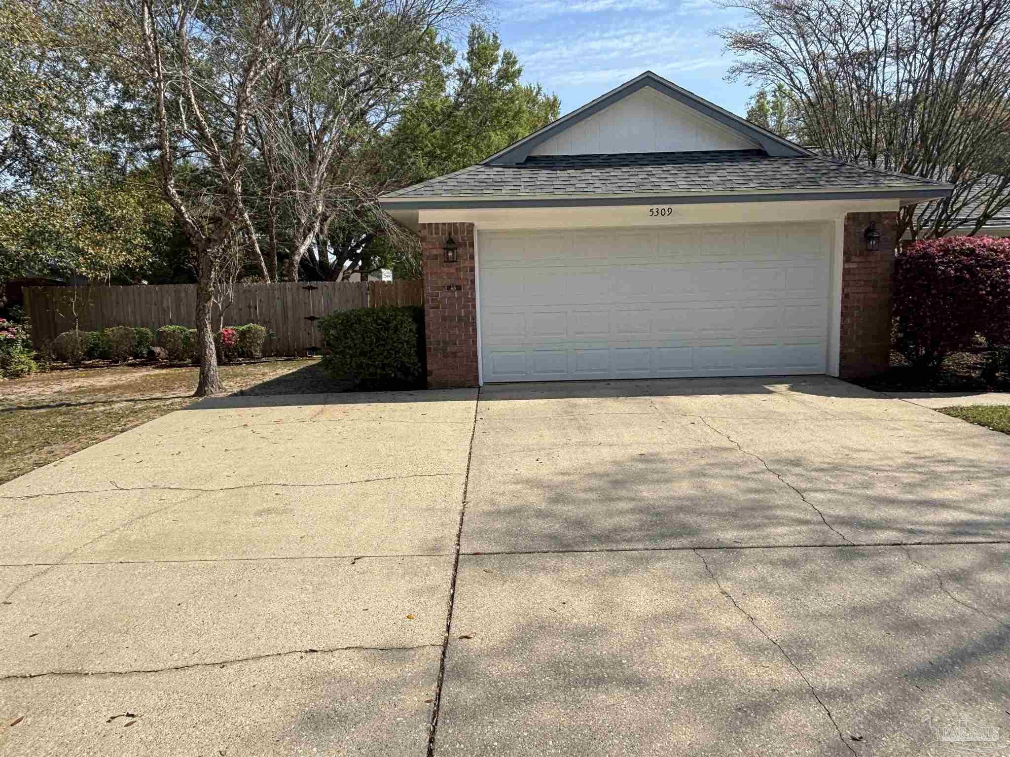 5309 Gillette Way Milton, FL 32570 - Photo 31 of 51 a front view of a house with a yard and garage