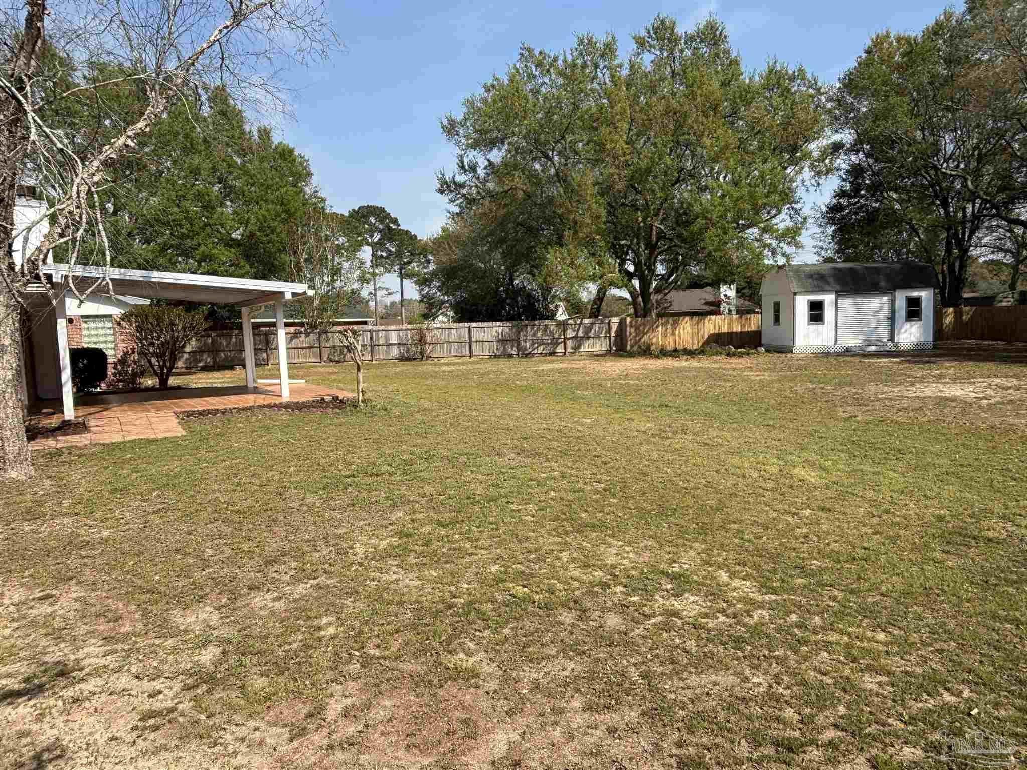 5309 Gillette Way Milton, FL 32570 - Photo 39 of 51 a view of a house with floor to ceiling windows and a yard