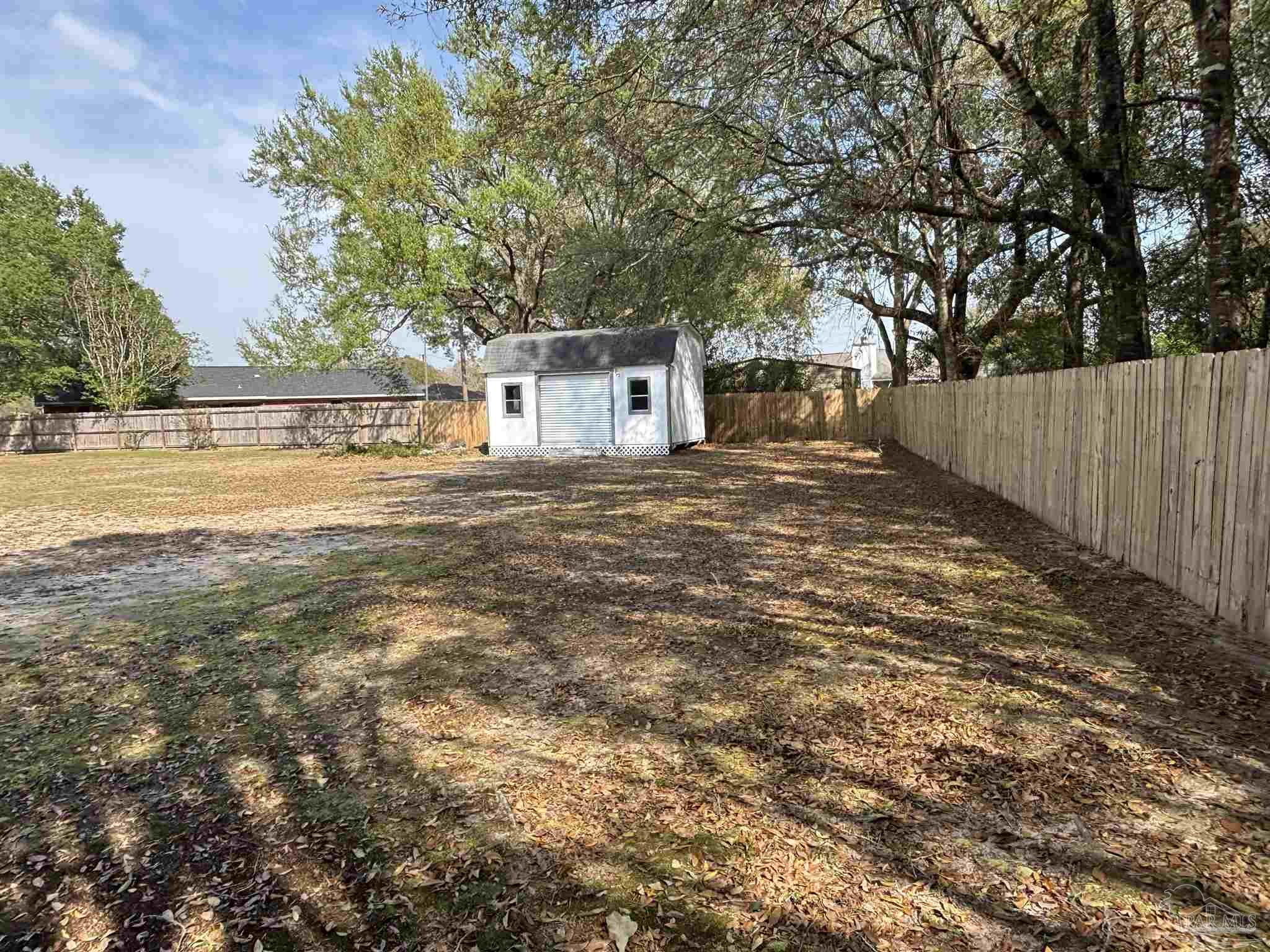 5309 Gillette Way Milton, FL 32570 - Photo 40 of 51 a front view of a house with a yard and trees