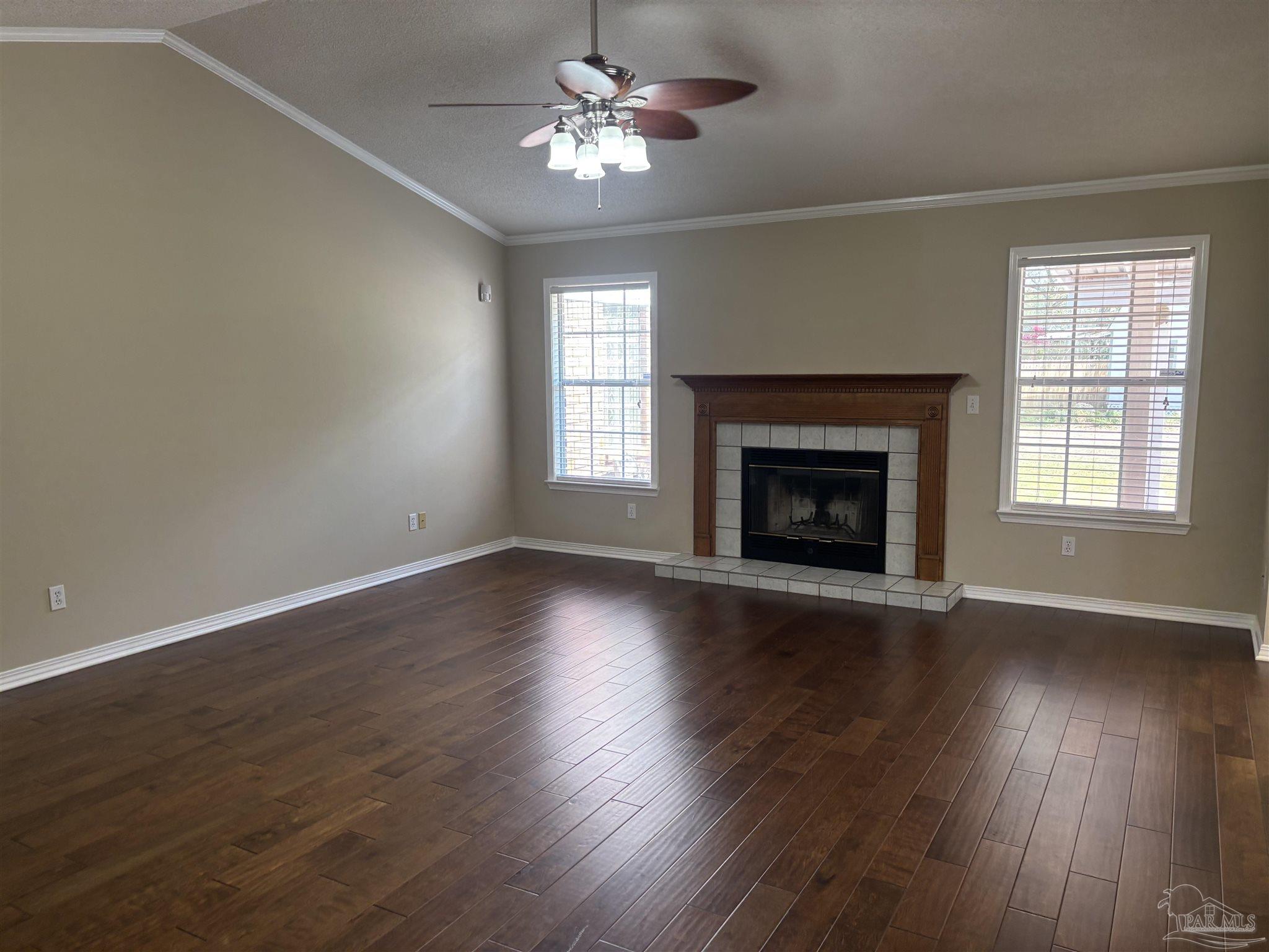 5309 Gillette Way Milton, FL 32570 - Photo 6 of 51 a view of an empty room with wooden floor fireplace and a window