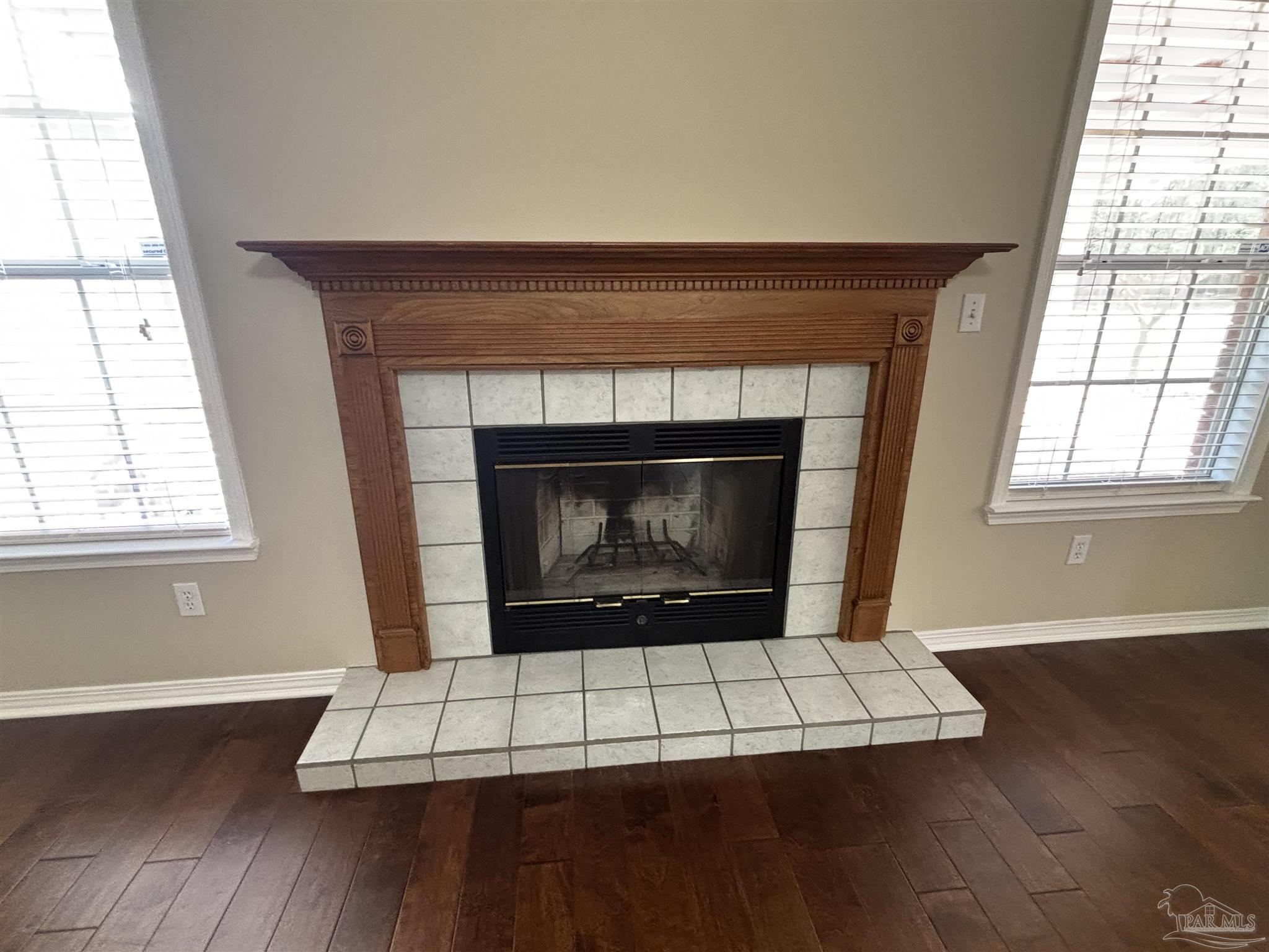 5309 Gillette Way Milton, FL 32570 - Photo 7 of 51 a living room with a fireplace with wooden floor