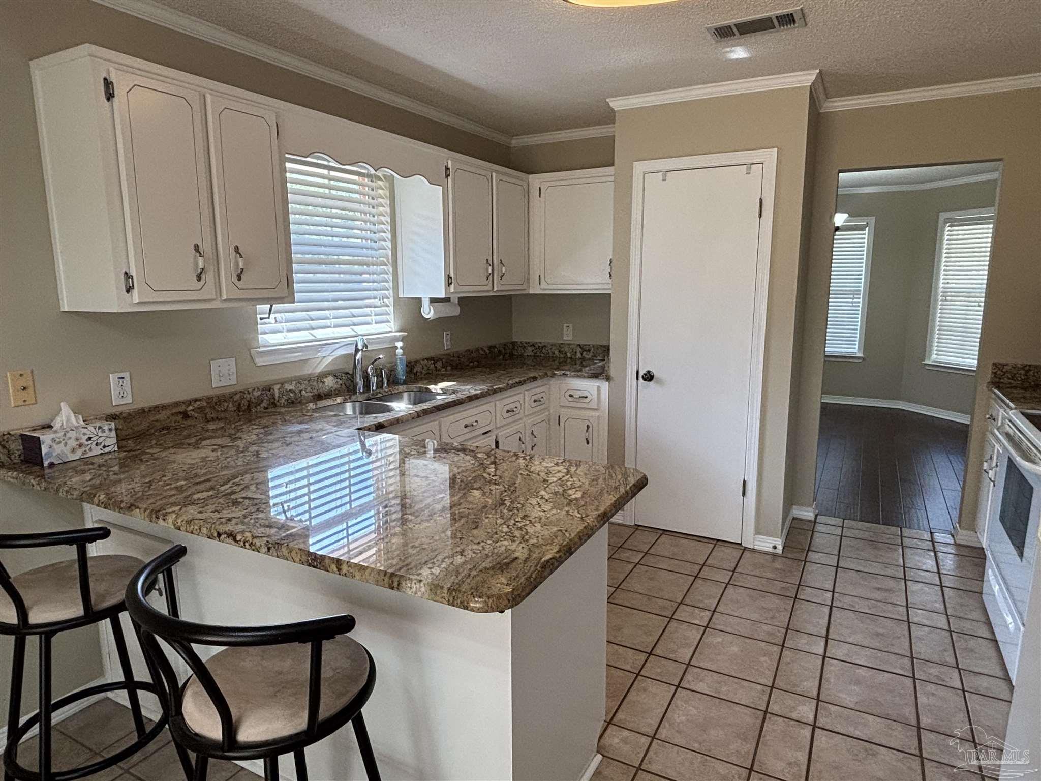 5309 Gillette Way Milton, FL 32570 - Photo 8 of 51 a kitchen with stainless steel appliances granite countertop a sink and cabinets