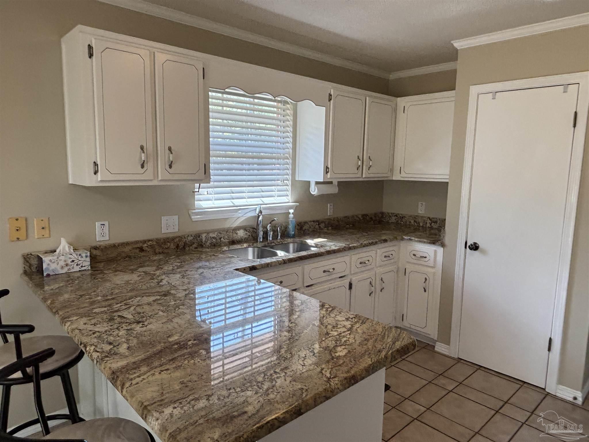5309 Gillette Way Milton, FL 32570 - Photo 10 of 51 a kitchen with granite countertop a sink stove and cabinets