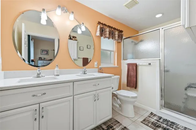a bathroom with a toilet a sink and a mirror