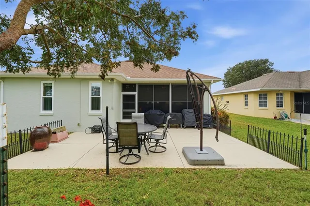 a view of house with a backyard and porch