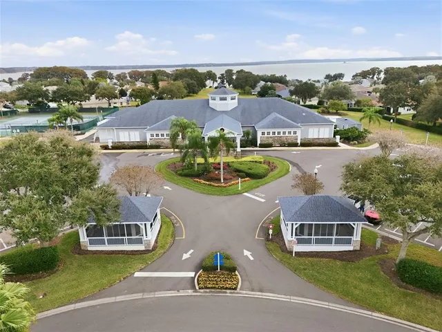 an aerial view of multiple houses with a lake view