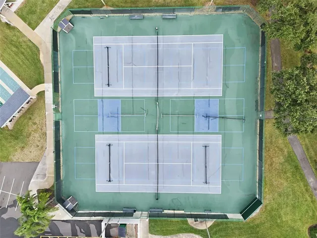 a view of a brick house next to a yard