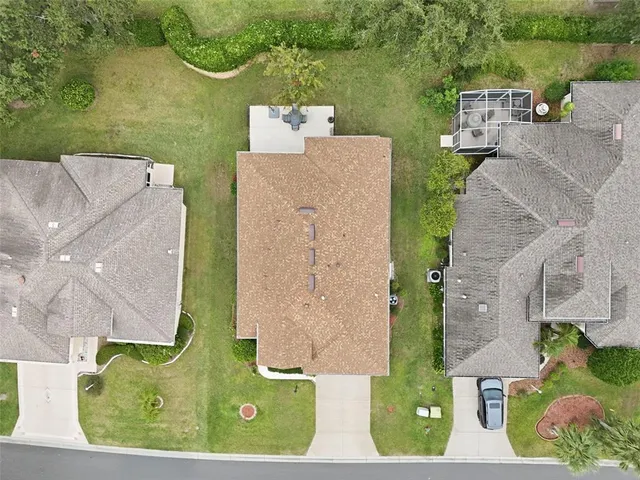 an aerial view of a house with a garden and pool