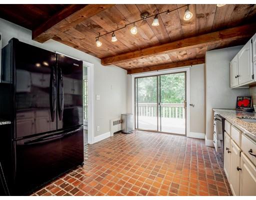 93 Edmands Road Framingham, MA 01701 - Photo 3 of 25 a open kitchen with granite countertop a refrigerator and a stove