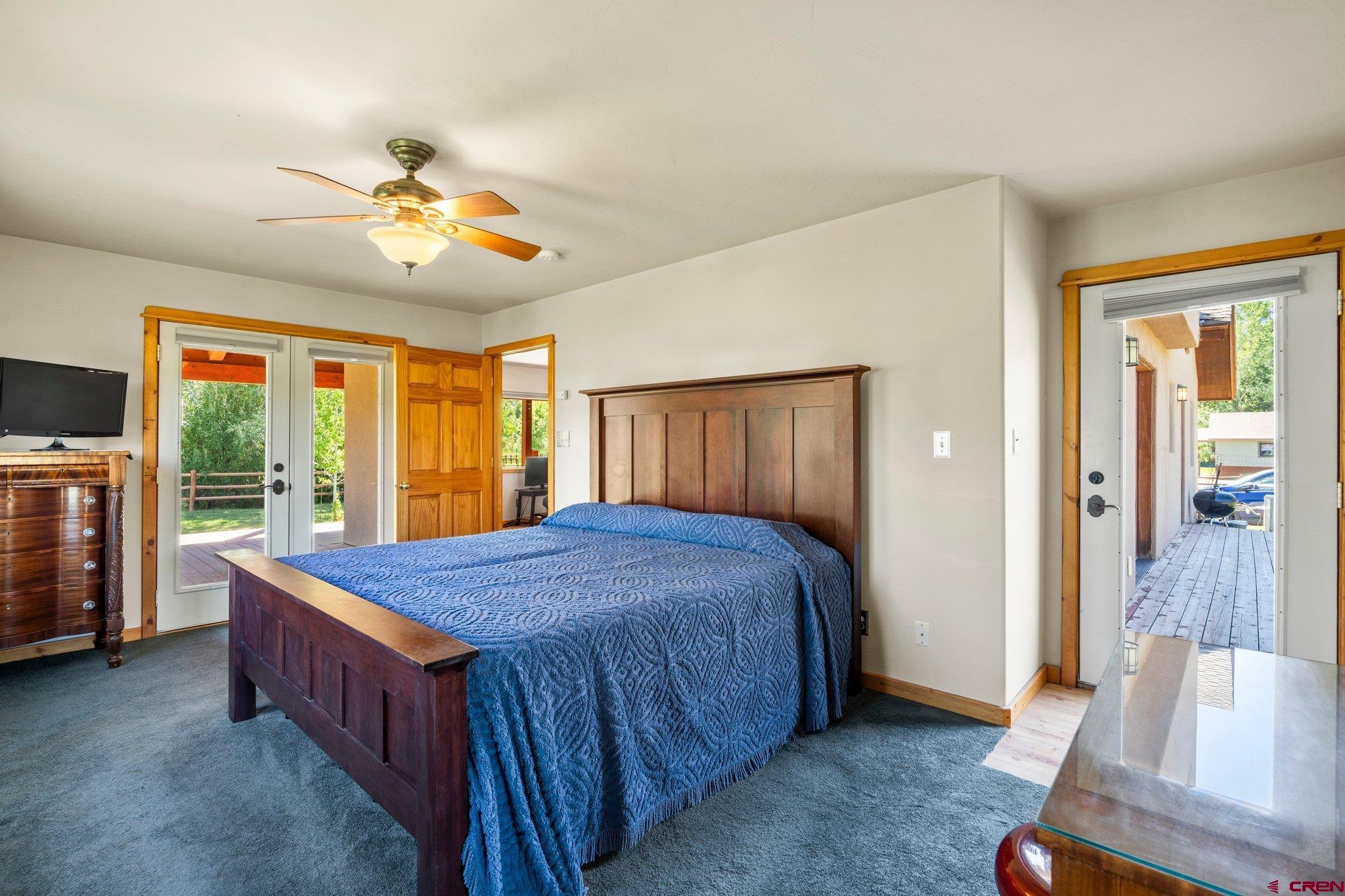 115 Pine River Ranch Circle Bayfield, CO 81122 - Photo 12 of 30 a bedroom with a bed and a chandelier