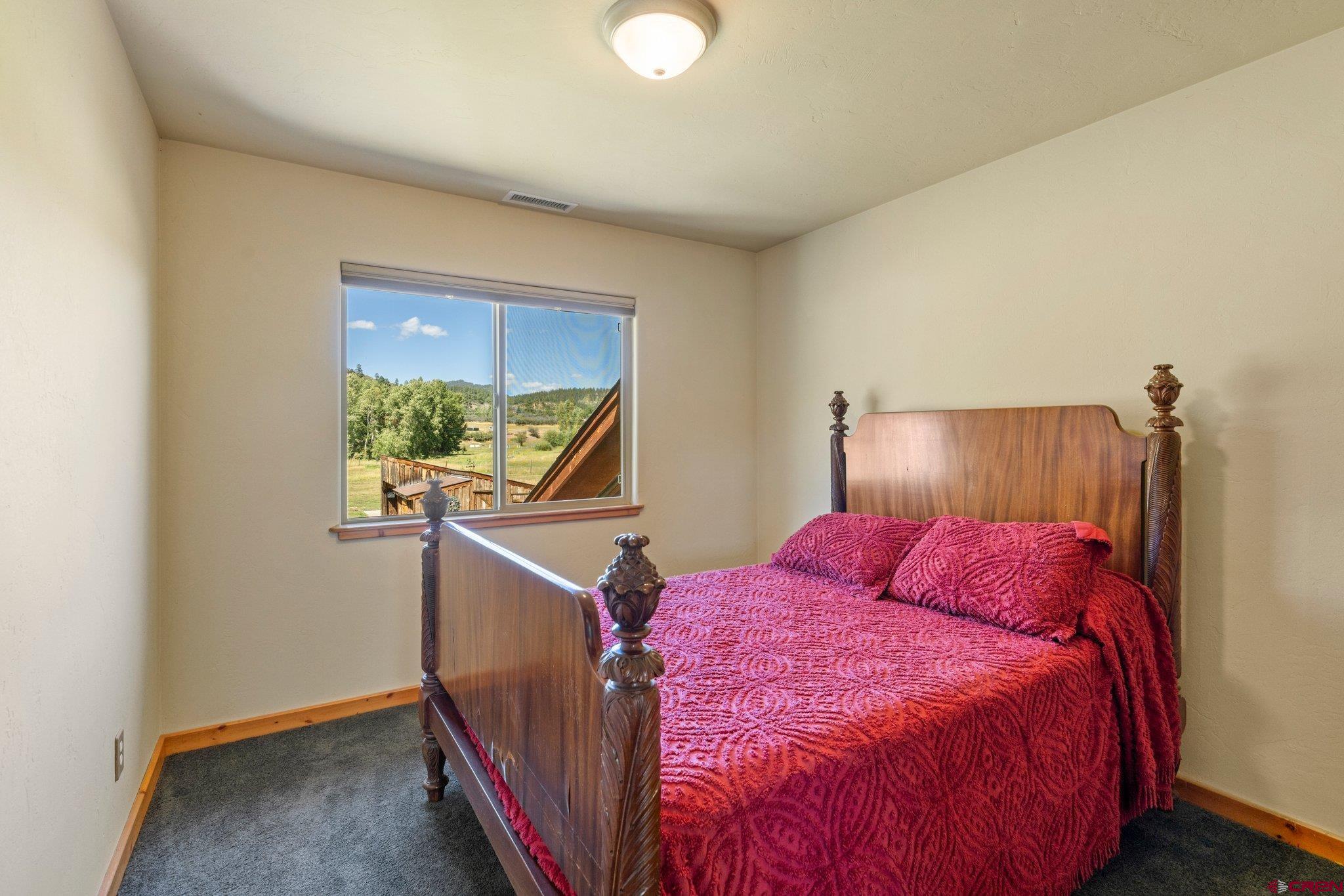 115 Pine River Ranch Circle Bayfield, CO 81122 - Photo 21 of 30 a bedroom with a bed and a window
