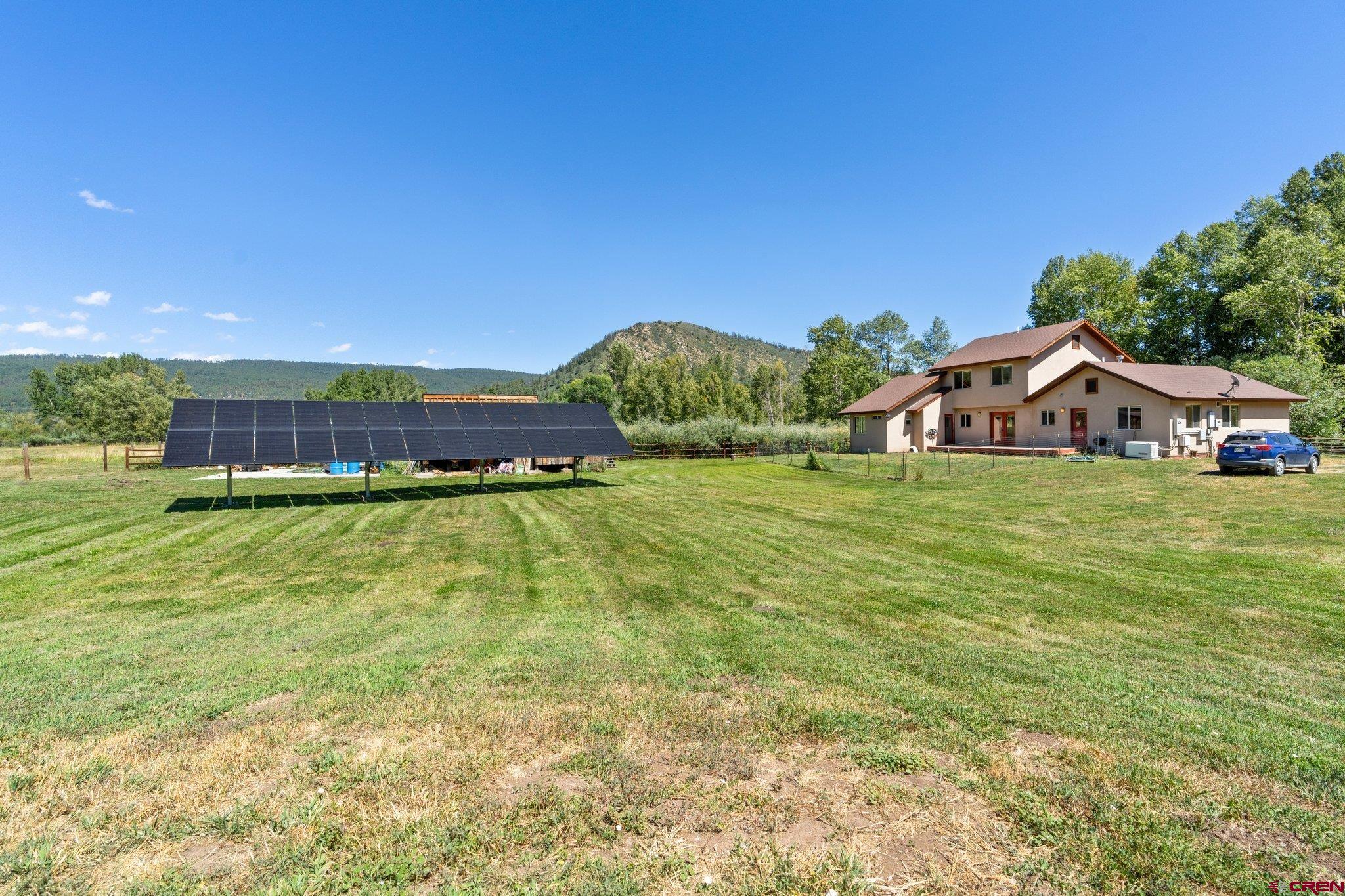 115 Pine River Ranch Circle Bayfield, CO 81122 - Photo 26 of 30 a view of a house with a big yard and large trees