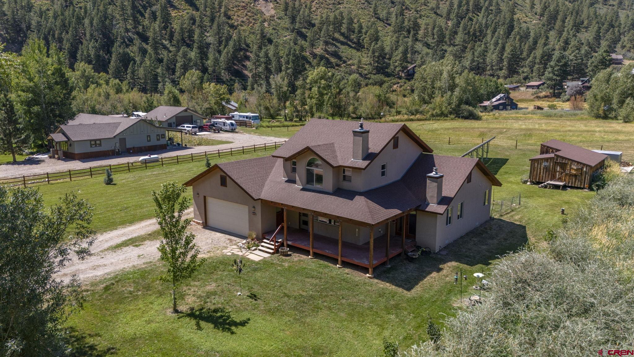 115 Pine River Ranch Circle Bayfield, CO 81122 - Photo 3 of 30 a view of a swimming pool with lawn chairs and a fire pit