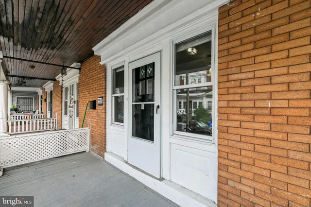 a view of a brick house with a large window