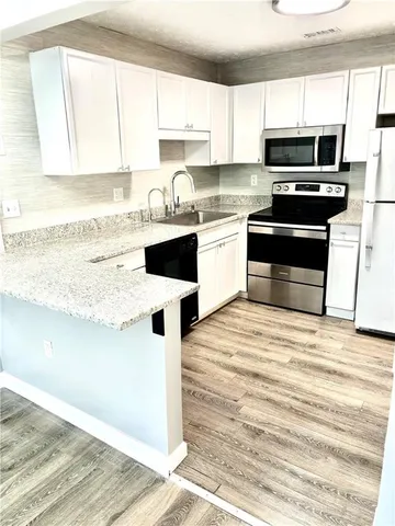 a kitchen with a stove a sink and a microwave