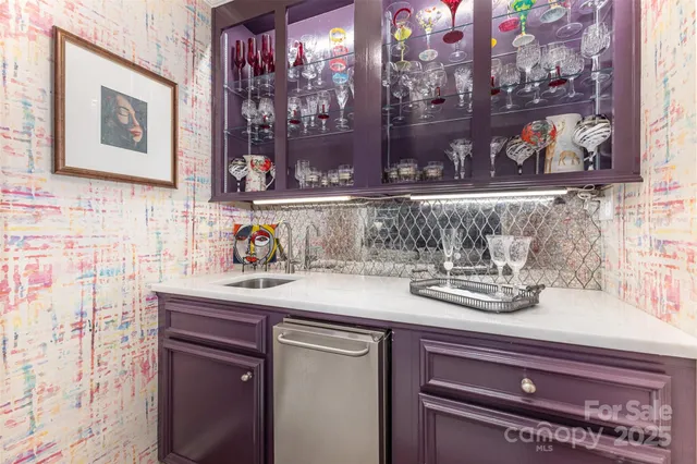 a kitchen with a sink and a painting on the wall