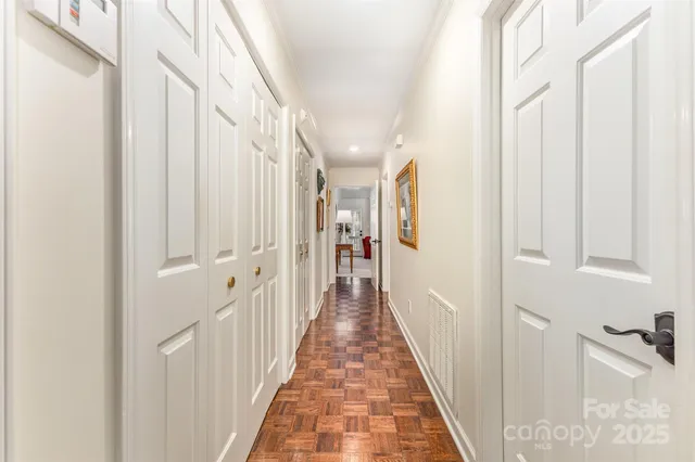 a view of a hallway with wooden floor and staircase