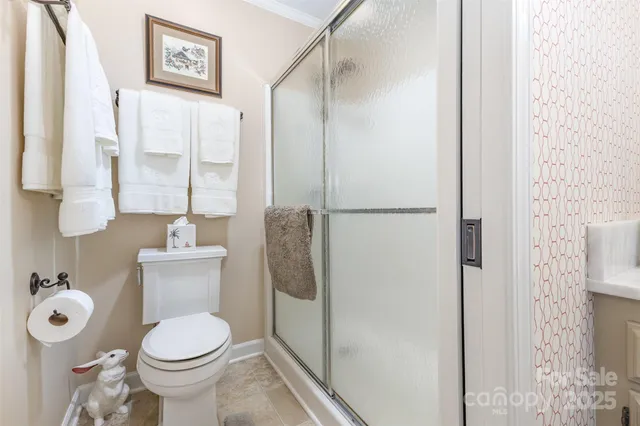a bathroom with a toilet and a shower