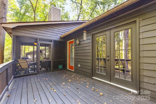 a porch with wooden floor and furniture