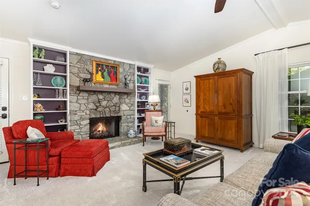 a living room with furniture a rug and a window