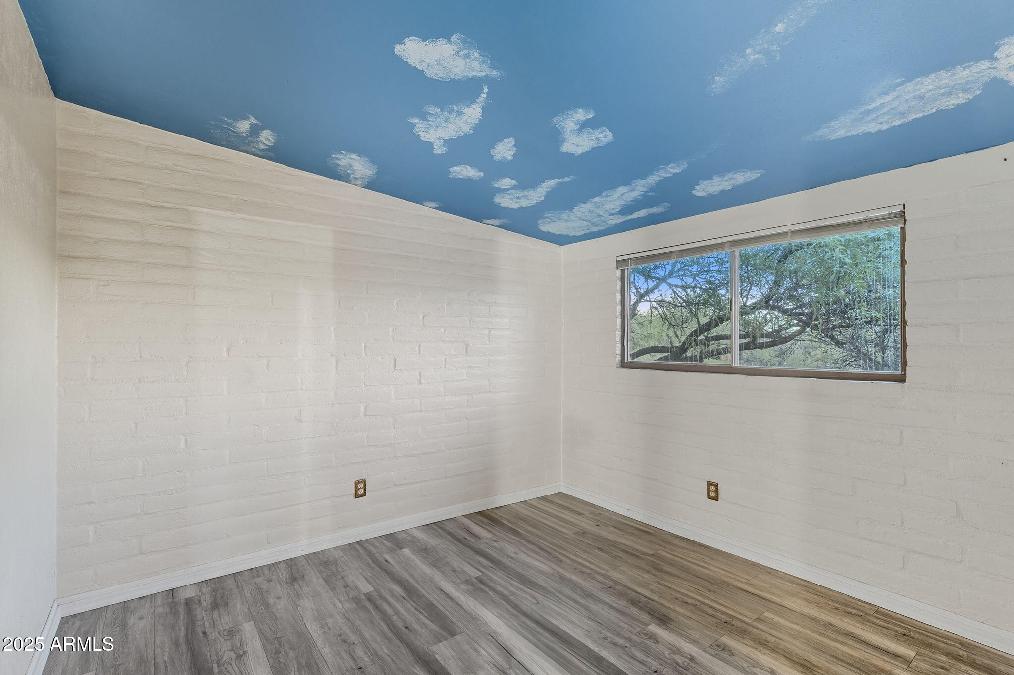 3036 West Williams Road Benson, AZ 85602 - Photo 21 of 50 a view of an empty room with wooden floor