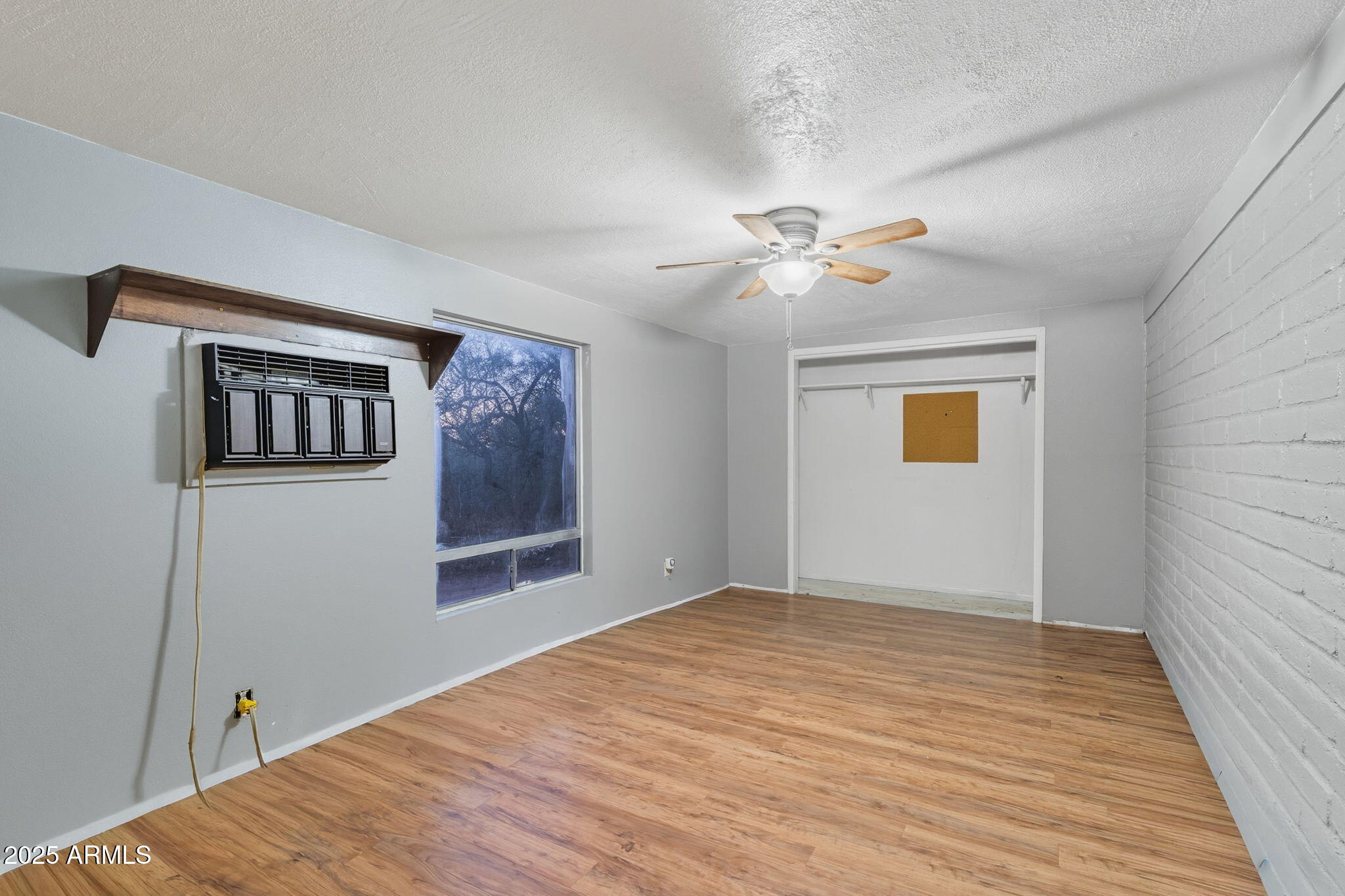 3036 West Williams Road Benson, AZ 85602 - Photo 24 of 50 a bedroom with a large bed and a chandelier