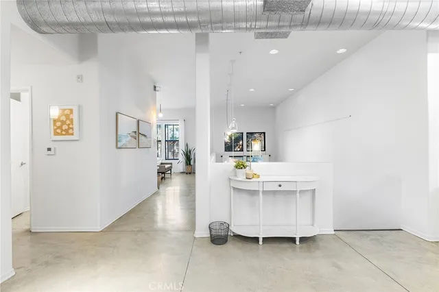 a living room with furniture and a book shelf