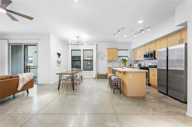 a kitchen with cabinets and chairs